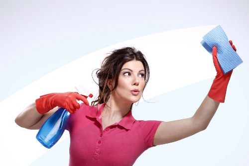 Professional cleaner sanitizing a kitchen countertop